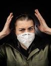 Woman wearing FFP2 mask questioning the covid-19 measurments depression anger Royalty Free Stock Photo