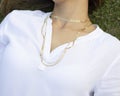 Woman wearing gold necklace. Necklace at the neck of young woman, women's accessories, gold necklace Royalty Free Stock Photo