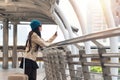 Woman wearing green hat and sunglasses with suitcase holding tablet in her hands directions searching something Royalty Free Stock Photo