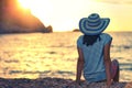 Woman wearing hat admire the sunset over the sea Royalty Free Stock Photo