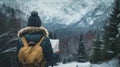 A woman wearing a hat and backpack in a snowy forest, hiking and winter travelling by foot, adventure concept. Royalty Free Stock Photo