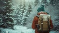 A woman wearing a hat and backpack in a snowy forest, hiking and winter travelling by foot, adventure concept. Royalty Free Stock Photo