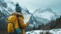 A woman wearing a hat and backpack in a snowy mountains, hiking and winter travelling, adventure concept. Royalty Free Stock Photo