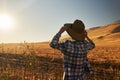 Woman wearing hat from behind looking at view of rural california landscape Royalty Free Stock Photo