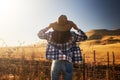 Woman wearing hat from behind looking at view of rural california landscape Royalty Free Stock Photo