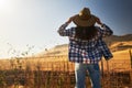Woman wearing hat from behind looking at view of rural california landscape Royalty Free Stock Photo