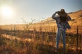 Woman wearing hat from behind looking at view of rural california landscape Royalty Free Stock Photo