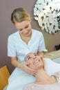 Woman wearing headscarf having head massage