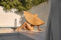 Woman in huge straw hat at poolside