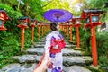 Woman wearing japanese traditional kimono holding man`s hand and leading him to Kifune shrine, Kyoto in Japan Royalty Free Stock Photo