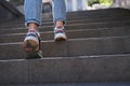 Woman wearing jeans and sneakers going up steep stairs Royalty Free Stock Photo