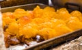 Woman wearing kitchen gloves and handling the mass of Smashed potato, to prepare a potato tortilla, ecuadorian Royalty Free Stock Photo