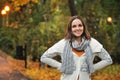 Woman wearing knitted jacket in autumn evening park.