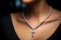 Woman wearing luxury jewelry, platinum necklace with diamonds close-up. Golden necklace on female neck. Beautiful diamond pendant