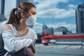 Woman wearing a mask in the city center