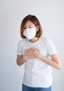 Woman wearing mask get sick from corona virus,, flu symptom as sneezing, cough, fever, body ache, breathing , pain Royalty Free Stock Photo