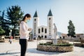 Woman wearing mask and gloves praying to God due to novel coronavirus covid-19 outbreak in Medjugorje.Woman in emotional stress