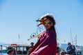 A woman wearing a mask parades wearing a carnival costume in a parade in Aegina island in Greece