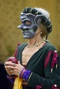 Woman wearing a mediaeval mask while holding a red apple Royalty Free Stock Photo