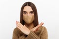 Woman wearing medical face mask showing crossed arms gesture, gesturing stop with hands, saying no to coronavirus Royalty Free Stock Photo