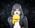 Woman wearing medical mask and cleaning gloves spraying a mist of disinfectant. Serious about keeping clean and virus free