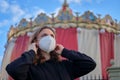 Woman is wearing a medical mask before holding public holidays. Safety of public events under quarantine due to flu virus Royalty Free Stock Photo