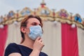 A woman is wearing a medical mask before holding public holidays. Safety of public events under quarantine due to flu virus Royalty Free Stock Photo