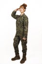Woman wearing military uniform giving a military hand salute with a smile