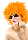 Woman wearing an orange feather wig and sunglasses Royalty Free Stock Photo