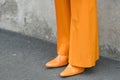 Woman wearing orange outfit: blazer jacket, pants and shoes Royalty Free Stock Photo