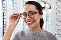 Woman wearing pair of trendy glasses, stylish spectacles and new prescription lenses at an optometrist. Portrait of a Royalty Free Stock Photo