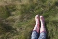 Woman Wearing Pink Galoshes Lying On Grass