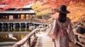 Woman wearing pink kimono on Wooden bridge in the autumn park, Japan autumn season, Kyoto Japan