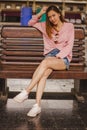 Woman sitting in a chair in a train station Royalty Free Stock Photo