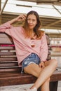 Woman sitting in a chair in a train station Royalty Free Stock Photo