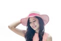 Woman wearing pink straw hat with expression of happy