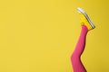 Woman wearing pink tights and sport shoes on yellow background, closeup. Space for text Royalty Free Stock Photo