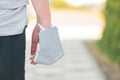 Woman wearing protective face mask around hand wrist