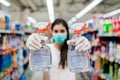 Woman wearing protective mask preparing for virus pandemic spread quarantine.Hygiene, cleaning and disinfection products.