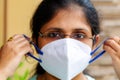 Woman wearing a protective n95 face mask as COVID-19 prevention awareness