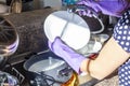 A woman wearing purple work gloves is doing dish washing. Royalty Free Stock Photo