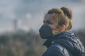 Woman wearing a real anti-pollution, anti-smog and viruses face mask