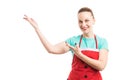 Woman wearing red apron showing or presenting copy space Royalty Free Stock Photo