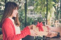 Woman wearing red cardigan give gift box to a man. hand get pres Royalty Free Stock Photo