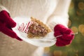 Woman Wearing Red Mittens Holding Plate of Pecan Pie, Peppermint Royalty Free Stock Photo