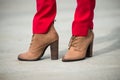 Woman wearing red pants and brown leather high heel shoes in old town Royalty Free Stock Photo