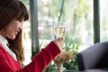 Woman wearing red sweater holding wine glass for birthday or ann Royalty Free Stock Photo