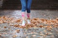 Woman wearing rubber boots after rain, focus on legs