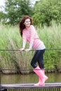 woman wearing rubber boots with umbrella in spring nature Royalty Free Stock Photo
