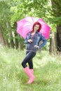 woman wearing rubber boots with umbrella in spring nature Royalty Free Stock Photo